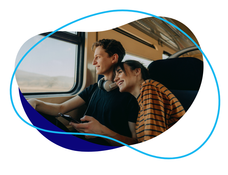 a boy and girl couple on a train looking out of window